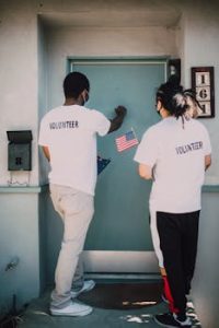 Two Men Knocking on the Blue Door