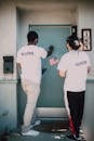 Two Men Knocking on the Blue Door